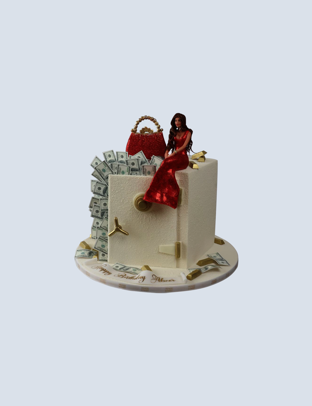 Money-themed birthday cake featuring a woman in a red dress, surrounded by faux dollar bills and a red handbag, with a safe design and "Happy Birthday Abeer" inscription.