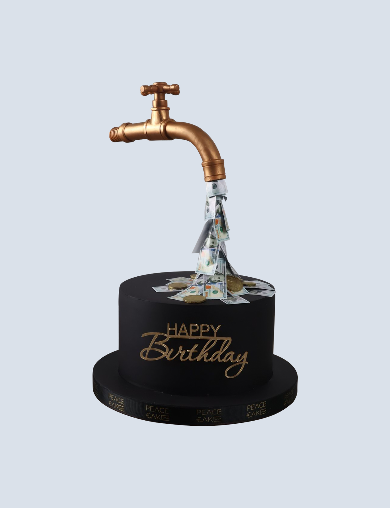 Birthday cake design featuring a faucet pouring out money, with "Happy Birthday" text and decorated with cash and coins, representing money-themed cake options from Peace of Cake.